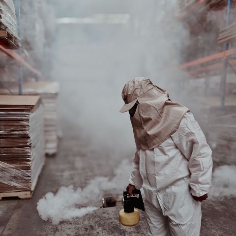Technician fogging a warehouse